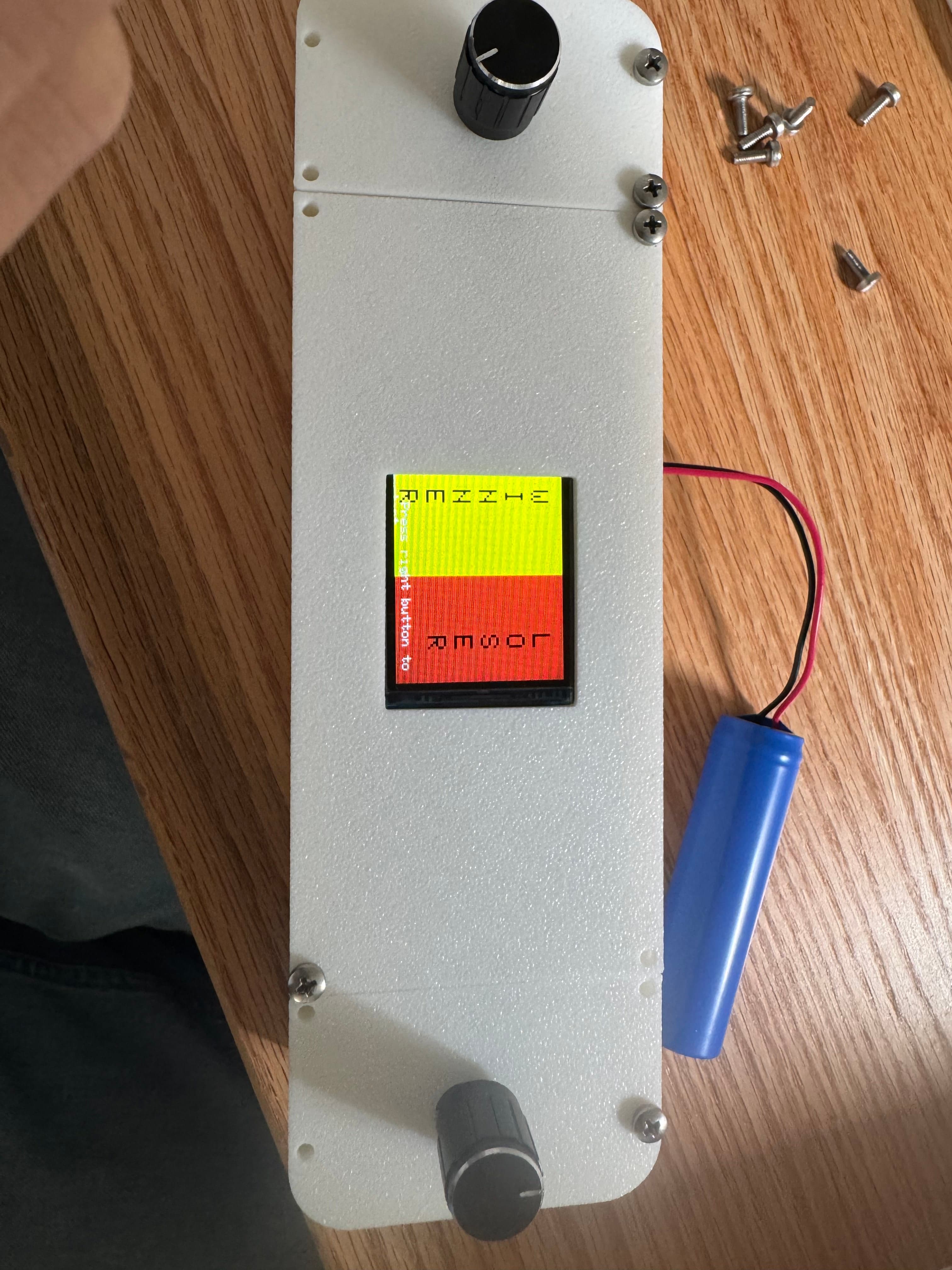 Handheld Pong console powering on